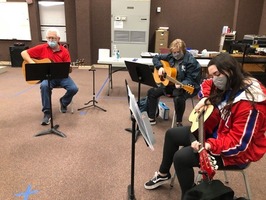 Melbourne students learn how to play the guitar